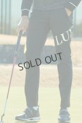 LUXEAKMPLUS リュクスエイケイエムプラス ゴルフ ビッグロゴ防風ロングパンツ{-BDA}